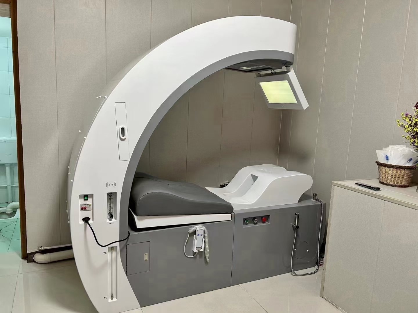 Clean and organized wellness clinic treatment room with colon hydrotherapy equipment