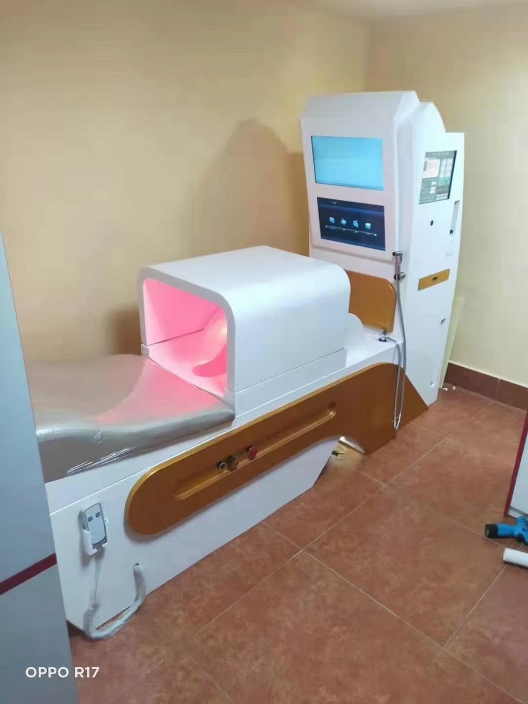 Technician performing final testing on completed MAIKONG colon hydrotherapy machine