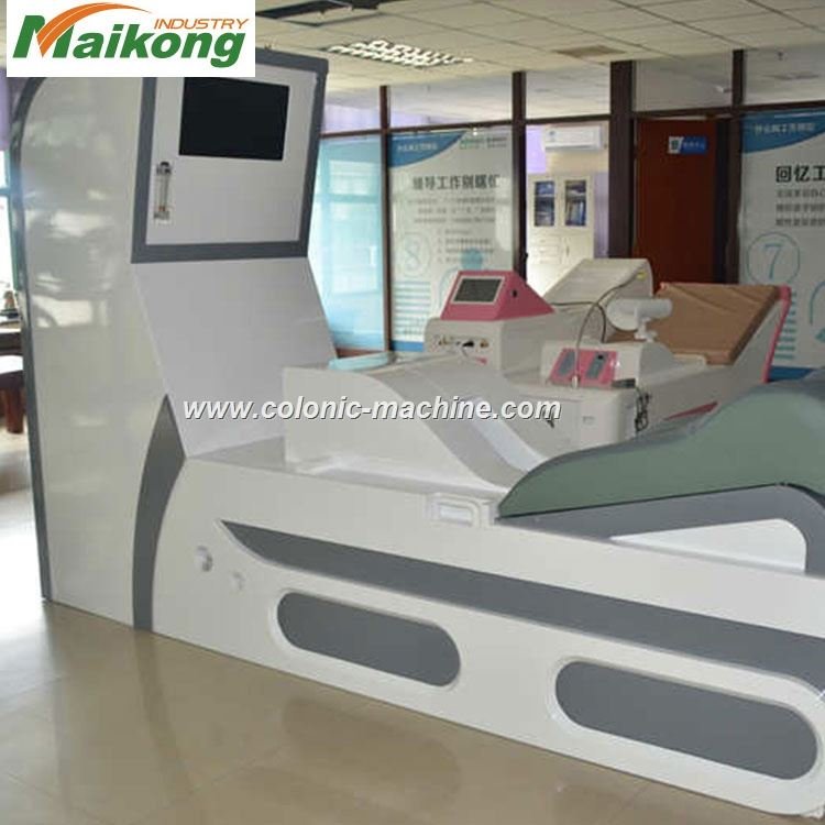 Quality control technician testing MAIKONG colon hydrotherapy machine on factory floor